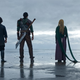 six figures looking at the ocean